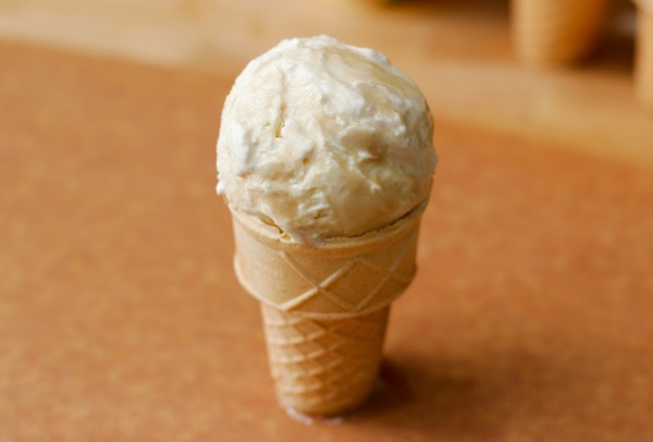 A scoop of ice cream in a cone, covered with root beer