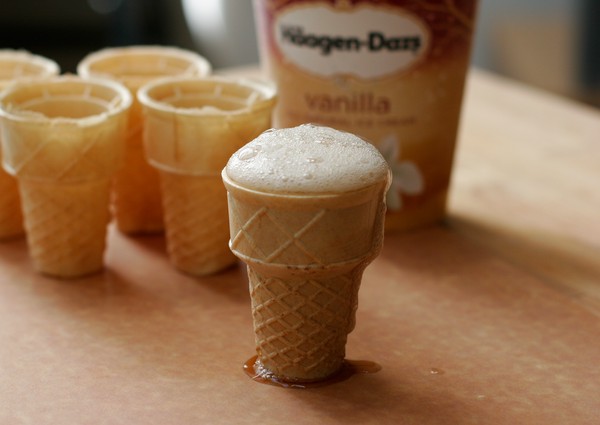 Foaming root beer Root beer foaming over the rim of a flat-bottomed ice cream cone